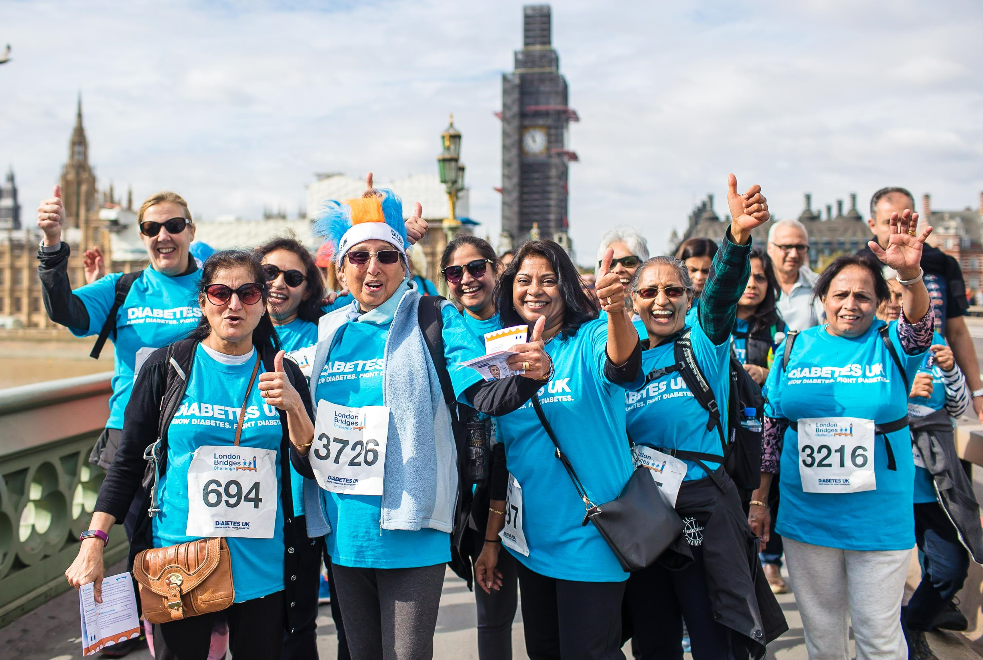 Group of people waving at Diabetes UK London Bridges event