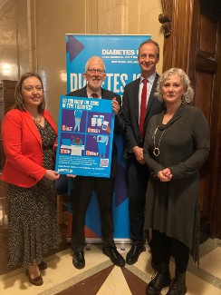 Deborah Erskine, Stewart Dickson, Chris Askew and Tina McCrossan at Stormont, holding the 4Ts poster with symptoms; Toilet, Thirsty, Tired, Thinner