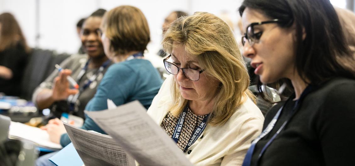 healthcare professionals studying documents at a training event