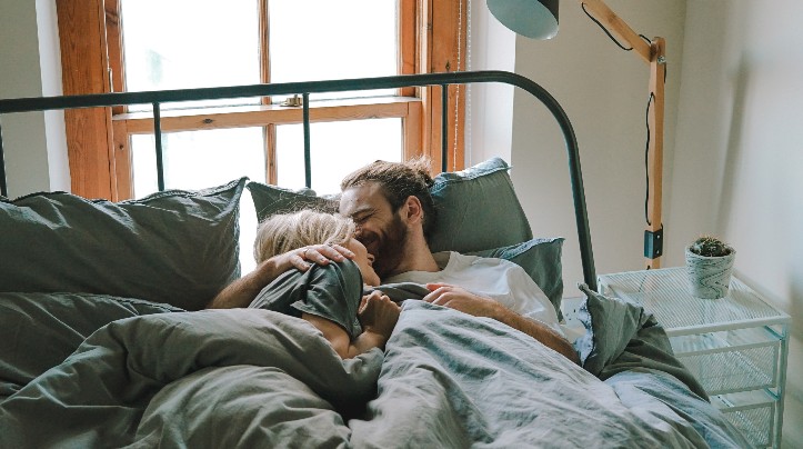 Couple cuddling in bed