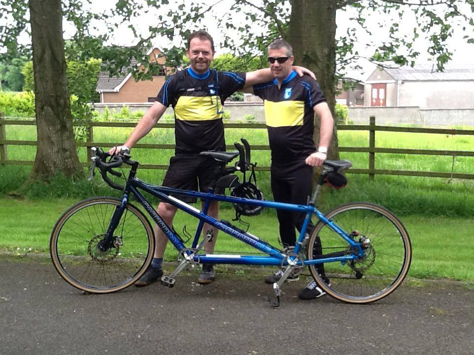 Charlie and Paul pictured with a tandem bicycle 