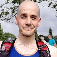 Male in Diabetes UK running vest smiling at camera.