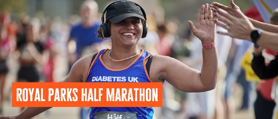 Female runner high fiving crowd in Diabetes UK vest