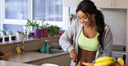 Woman chopping food in a kitchen