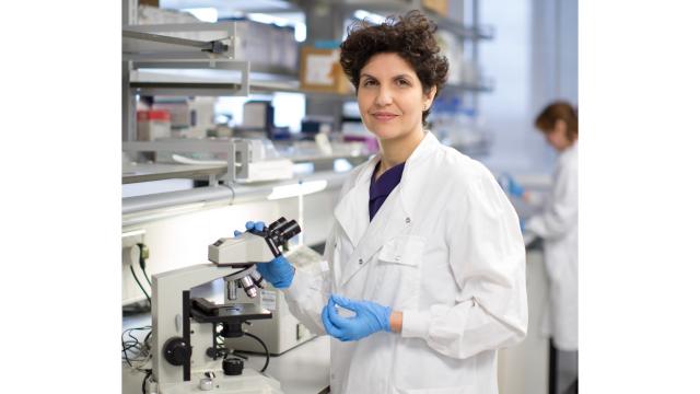 A researcher stands in a lab