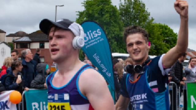 A male runner punching the air as he runs past during a race