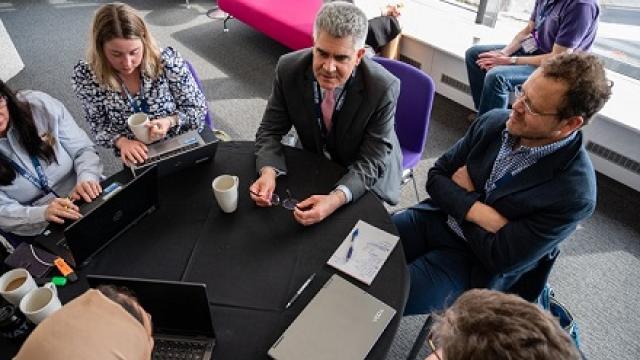 Healthcare professionals talking around a table