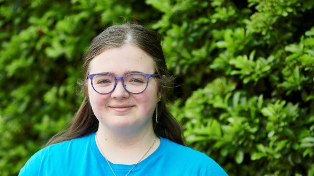 A girl wearing a Diabetes UK tshirt is smiling at the camera.