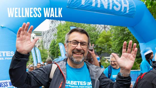 Man at finish line to a wellness walk