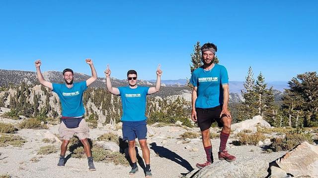 3 men in the hot sun somewhere in the North American wildlands, each wearing a t-shirt that reads: Diabetes UK.