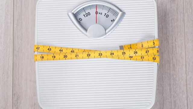 Pair of weighing scales with a measuring tape