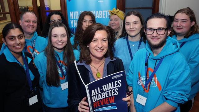 The image shows the Minister for Health and Social Services in Wales with a group of young leaders.