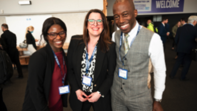 three people smiling at camera