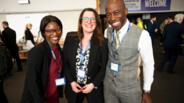 three people smiling at camera