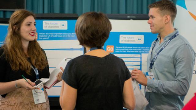 image of volunteers at an event talking 