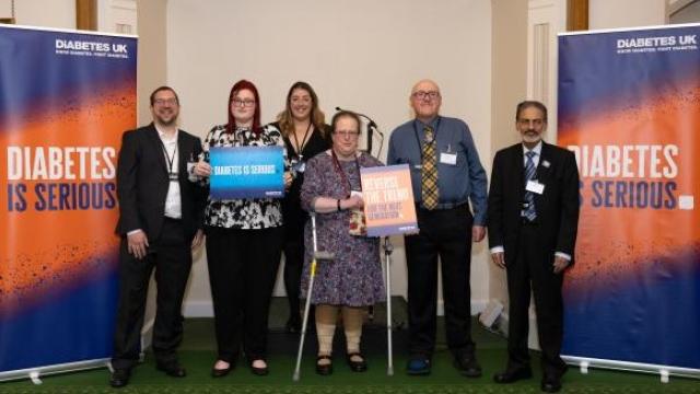 A group of supporters in front of Diabetes is Serious banners