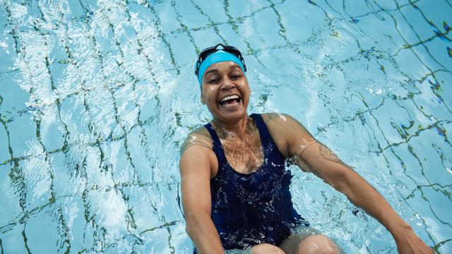 Lady smiling and swimming in the pool