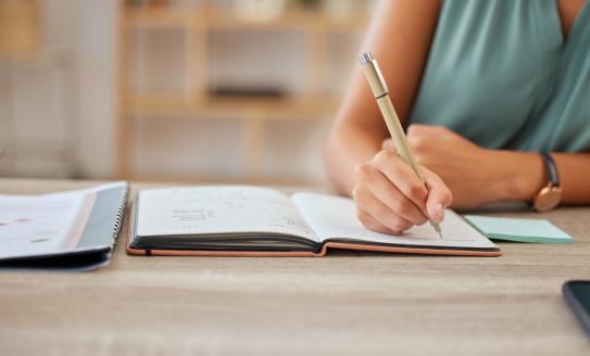 Photo of person in blue top writing 