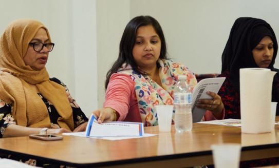 three non-white women sitting at a table