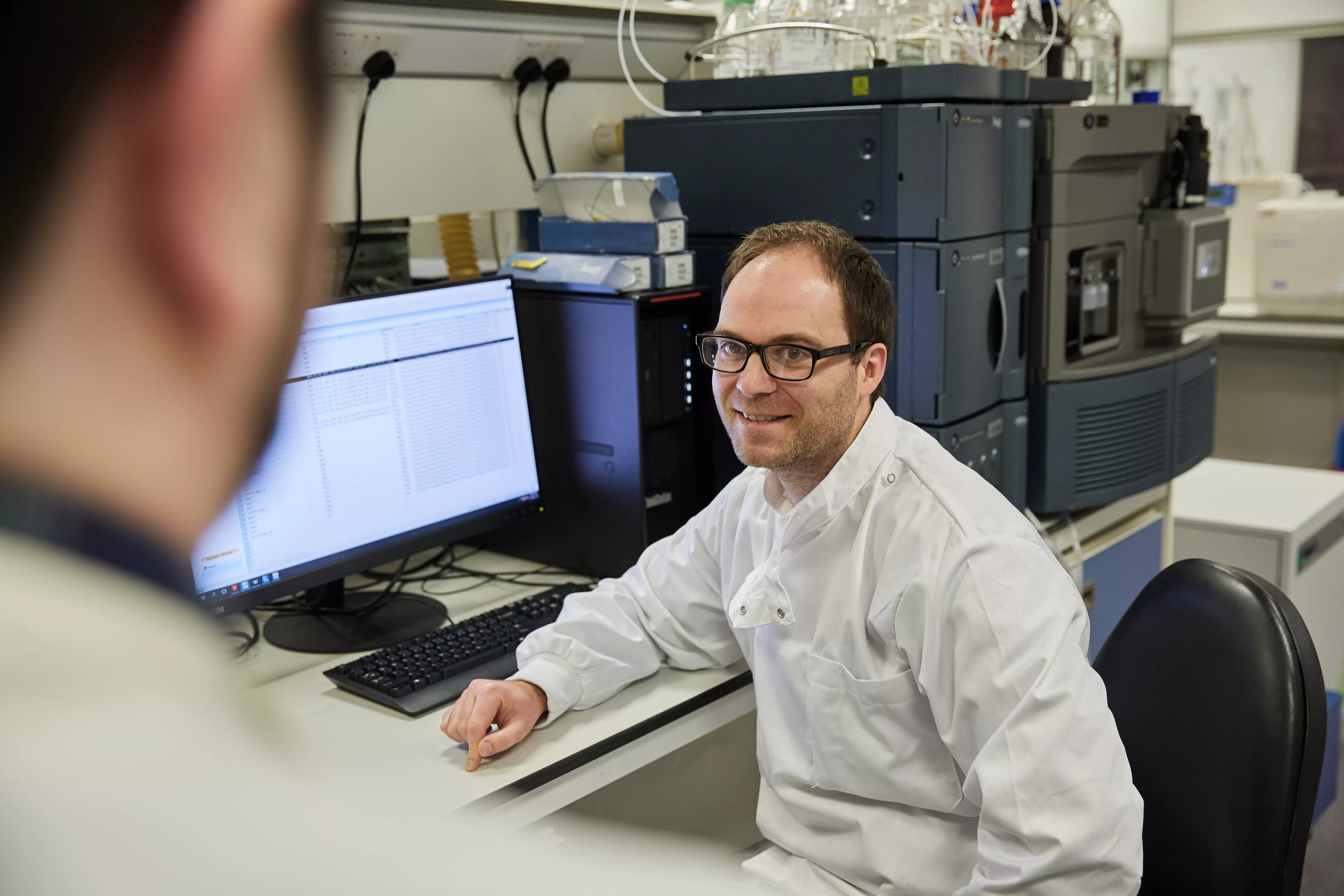 Dr Lee Roberts smiling in a scientific lab