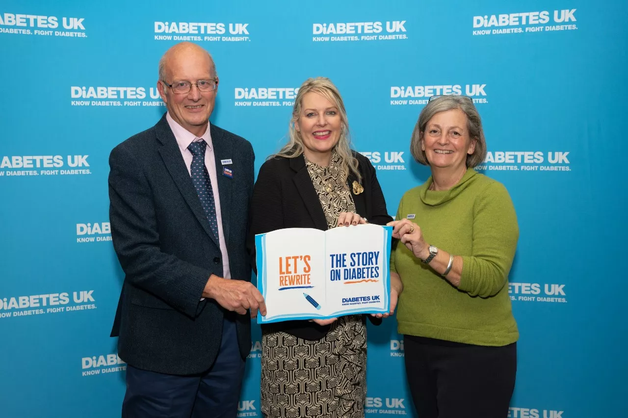 Martin Emmerson, Mims Davies MP and Caroline Cross holding a sign saying 'let's rewrite the story on diabetes'