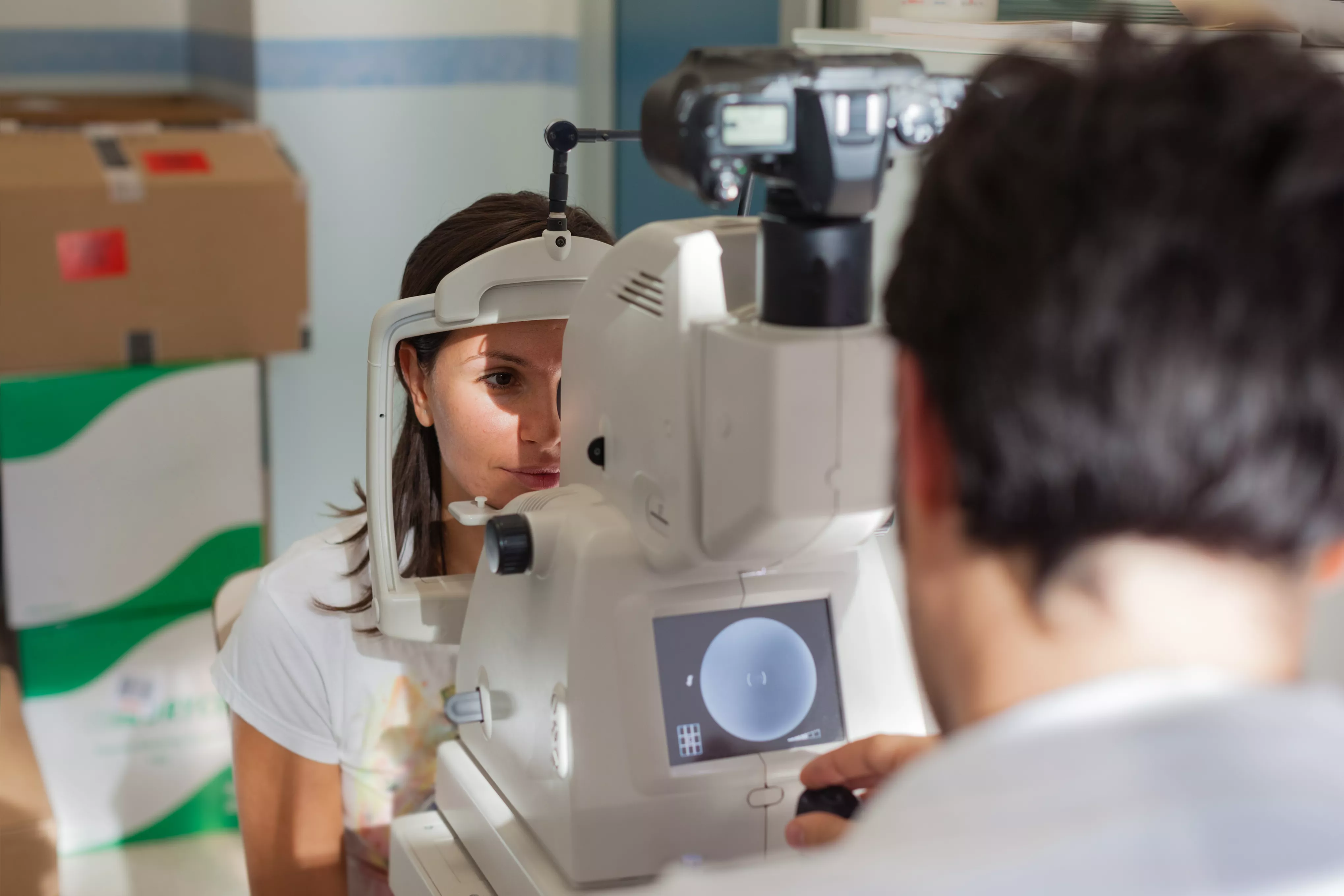 A person having their eyes screened by a healthcare professional