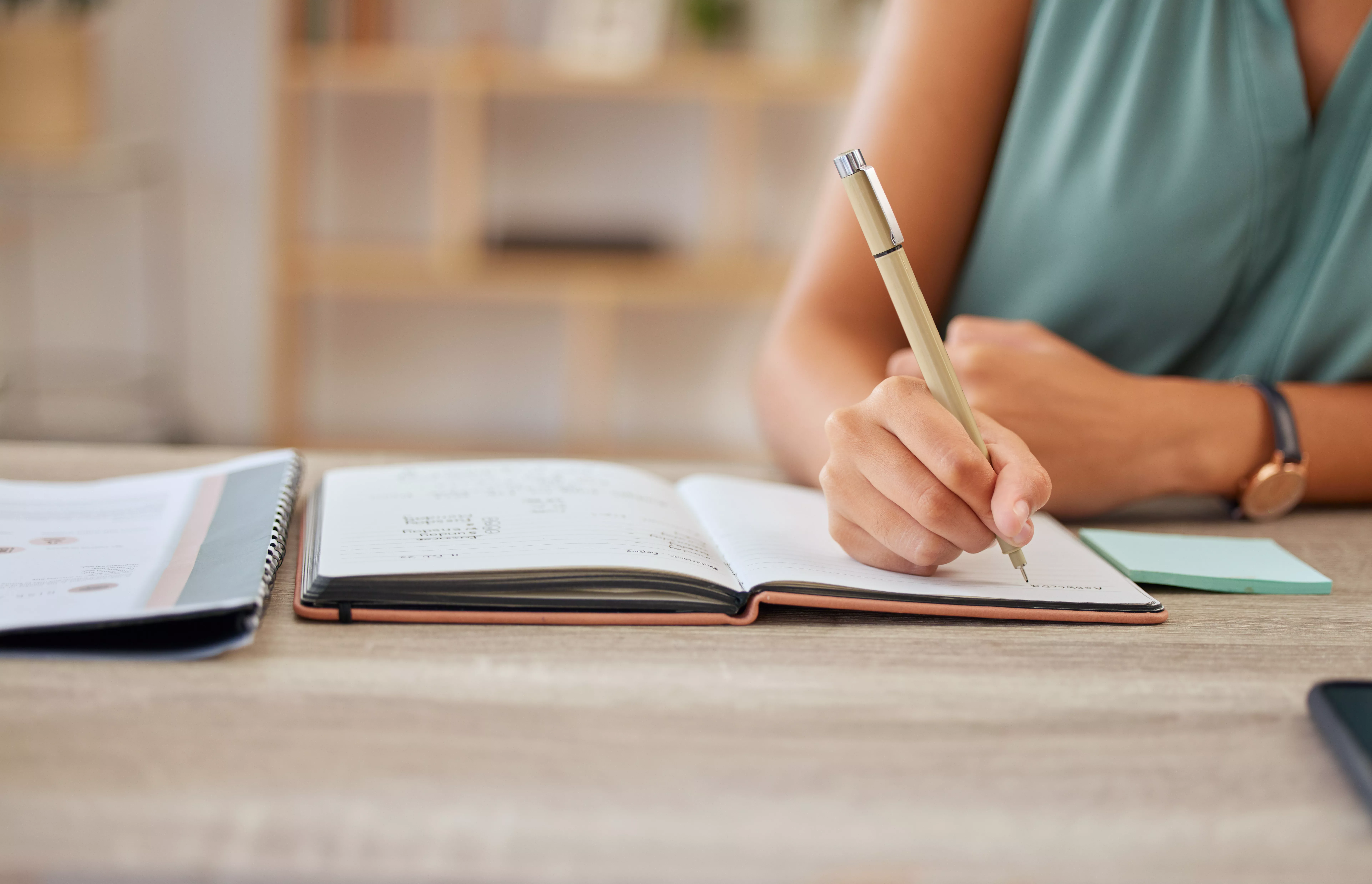 Photo of person in blue top writing 