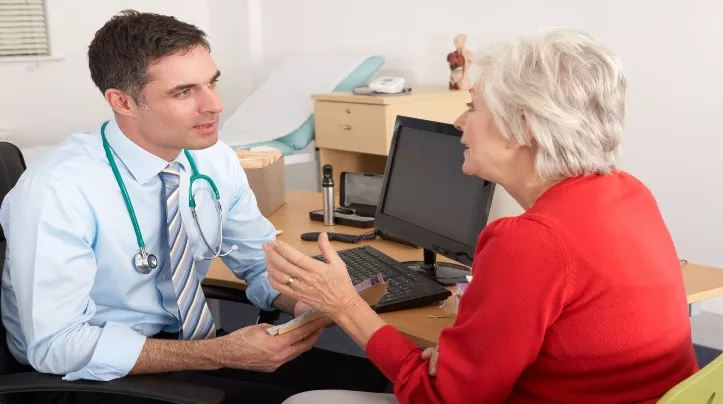 doctor talking to female patient 