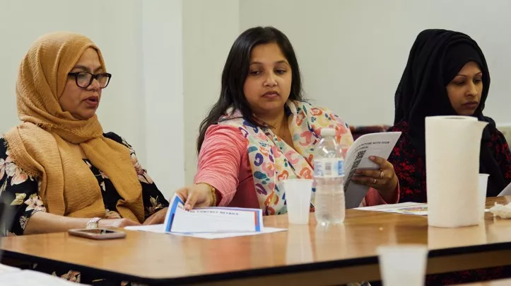 three non-white women sitting at a table