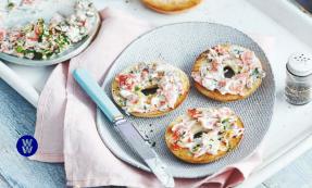 Mini salmon bagels on a plate with a knife