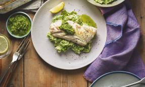 A plate of haddock with salsa verde,broccoli and bean mash