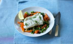 Braised cod with peas, spring onions and carrots