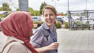 HCP walking outside alongside a patient talking